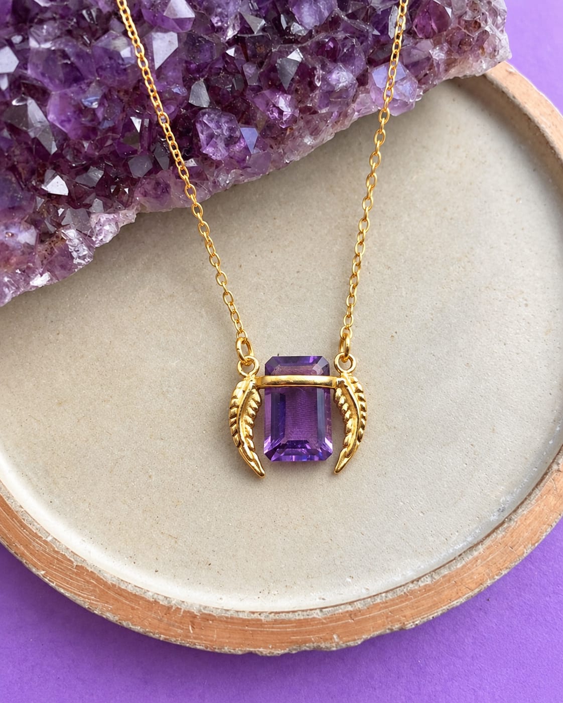 Purple pendant with leaf-shaped details